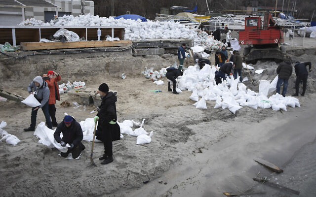 Volunteers fill sandbags to build barricades in Odesa, Ukraine, March 5, 2022. (AP Photo/Max Pshybyshevsky)