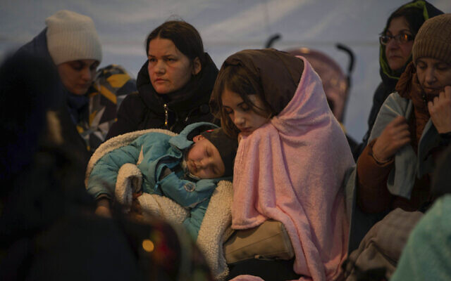 Refugees, mostly women with children, rest inside a tent after arriving at the border crossing, in Medyka, Poland on March 6, 2022. (AP Photo/Visar Kryeziu) Refugees, mostly women with children, rest inside a tent after arriving at the border crossing, in Medyka, Poland on March 6, 2022. (AP Photo/Visar Kryeziu)