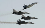Two Polish Air Force Russian-made Mig-29s fly above and below two Polish Air Force US-made F-16 fighter jets during an air show in Radom, Poland, August 27, 2011. (AP Photo/Alik Keplicz, File)