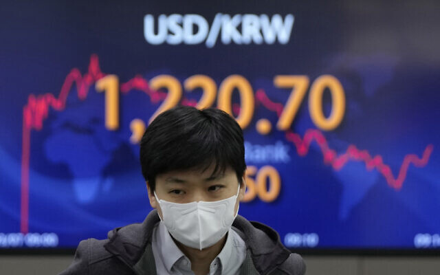 A currency trader walks near the screen showing the foreign exchange rate between US dollar and South Korean won at a foreign exchange dealing room in Seoul, South Korea, March 7, 2022 (AP Photo/Lee Jin-man) A currency trader walks near the screen showing the foreign exchange rate between US dollar and South Korean won at a foreign exchange dealing room in Seoul, South Korea, March 7, 2022 (AP Photo/Lee Jin-man)