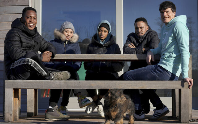Emmanuel Oyedele, from left, Deborah Samuel, Shalom Odion, Kurrah David and host Christian Vollmann pose for a photo after an interview with The Associated press in Gross Koeris near Berlin, Germany, March 7, 2022. (AP Photo/Michael Sohn) Emmanuel Oyedele, from left, Deborah Samuel, Shalom Odion, Kurrah David and host Christian Vollmann pose for a photo after an interview with The Associated press in Gross Koeris near Berlin, Germany, March 7, 2022. (AP Photo/Michael Sohn)