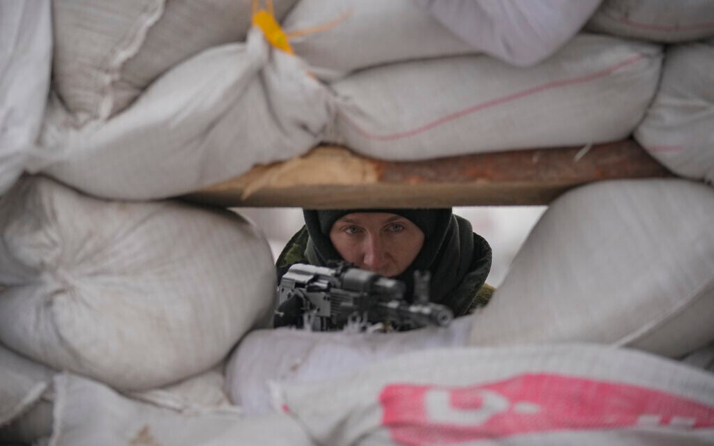 A Ukrainian serviceman guards a checkpoint on a main road in Kyiv, Ukraine, Monday, March 7, 2022. (AP/Vadim Ghirda)