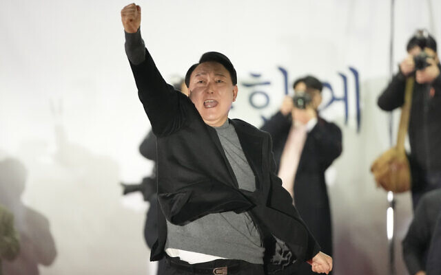 Yoon Suk-yeol, the presidential candidate of the main opposition People Power Party, raises his hand during a presidential election campaign in Seoul, South Korea, Tuesday, March 8, 2022. (AP Photo/Lee Jin-man) Yoon Suk-yeol, the presidential candidate of the main opposition People Power Party, raises his hand during a presidential election campaign in Seoul, South Korea, Tuesday, March 8, 2022. (AP Photo/Lee Jin-man)