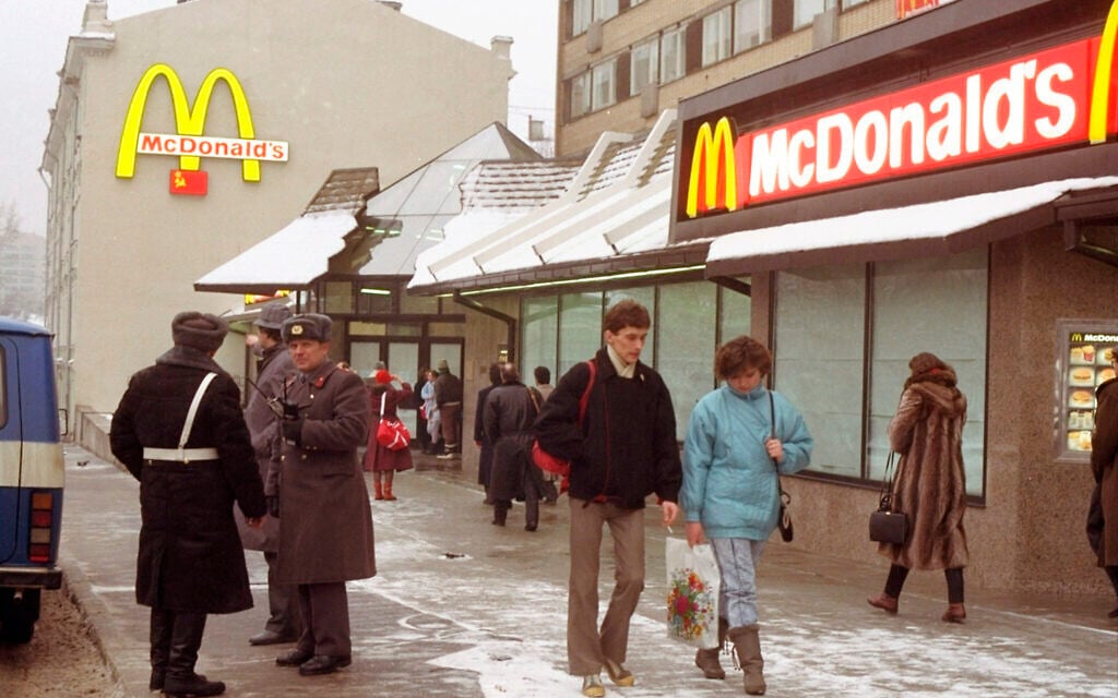 Illustrative: People walk past Moscow's first McDonalds a day before its opening, in Moscow's Pushkin Square, January 30, 1990. (AP Photo/Vicktor Yurchenko, File)