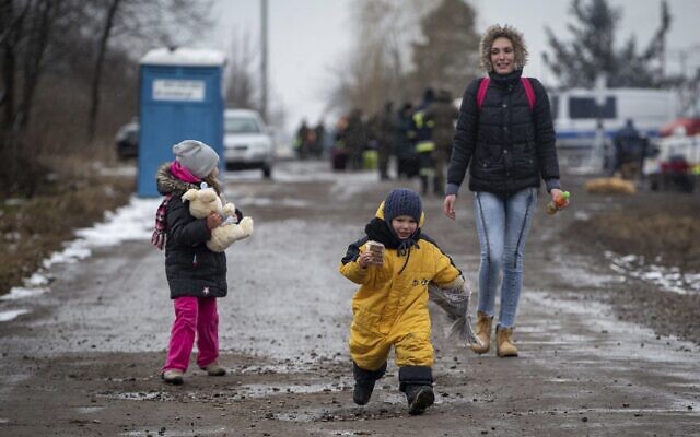 Children, followed by a woman, run as they arrive at the border crossing in Medyka, Poland, after fleeing Ukraine, March 9, 2022 (AP Photo/Visar Kryeziu) Children, followed by a woman, run as they arrive at the border crossing in Medyka, Poland, after fleeing Ukraine, March 9, 2022 (AP Photo/Visar Kryeziu)