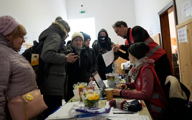 Refugees register for aid after fleeing the war from neighboring Ukraine, in Barabas, Hungary, March 9, 2022. (Darko Vojinovic/AP) Refugees register for aid after fleeing the war from neighboring Ukraine, in Barabas, Hungary, March 9, 2022. (Darko Vojinovic/AP)