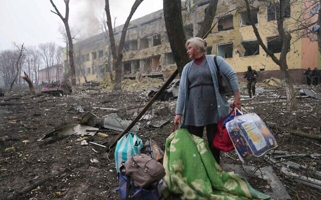 A woman walks outside a maternity hospital that was damaged by shelling in Mariupol, Ukraine, on Wednesday, March 9, 2022. (AP Photo/Evgeniy Maloletka) A woman walks outside a maternity hospital that was damaged by shelling in Mariupol, Ukraine, on Wednesday, March 9, 2022. (AP Photo/Evgeniy Maloletka)