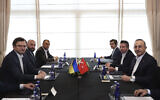 Ukraine's Foreign Minister Dmytro Kuleba, left, meets his Turkish counterpart Mevlut Cavusoglu, right, ahead of their tripartite meeting with Russia's Foreign Minister Sergey Lavrov, in Antalya, Turkey, March 10, 2022. (Fatih Aktas/Turkish Foreign Ministry via AP)