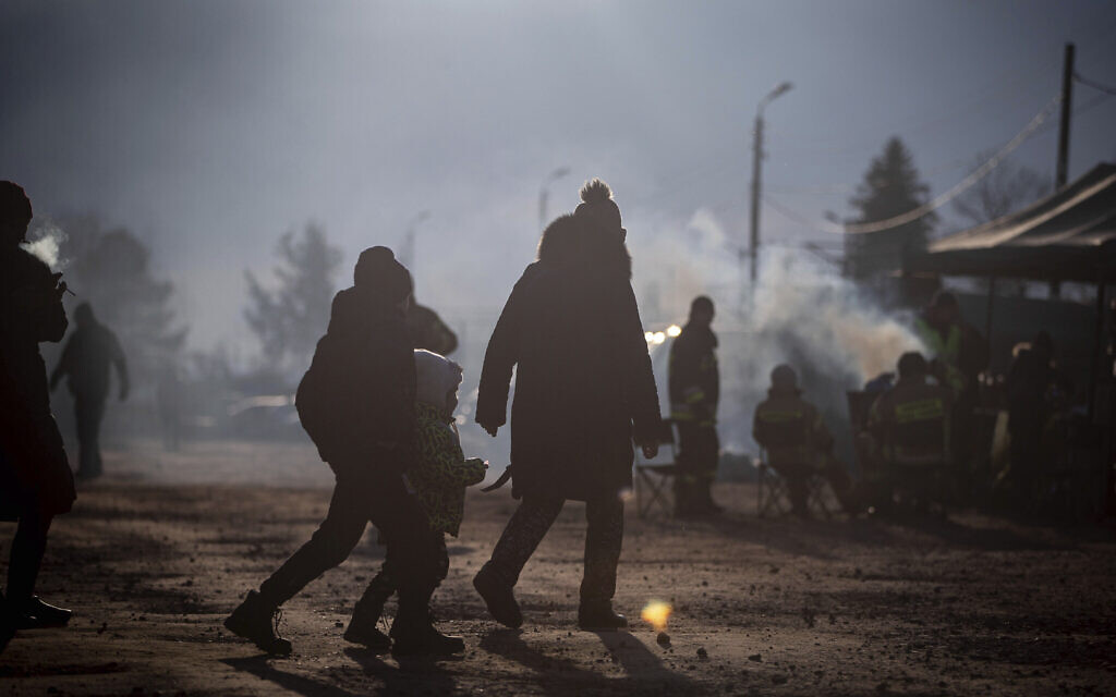 People at a makeshift camp wait to board a train heading for Krakow, after fleeing from Ukraine, at the border crossing in Medyka, Poland, Thursday, March 10, 2022. (AP/Visar Kryeziu)