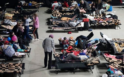 Refugees from the war in Ukraine seek shelter at a sports center in Warsaw, Poland, on March 11, 2022. (AP Photo/Czarek Sokolowski)