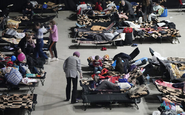 Refugees from the war in Ukraine seek shelter at a sports center in Warsaw, Poland, on March 11, 2022. (AP Photo/Czarek Sokolowski) Refugees from the war in Ukraine seek shelter at a sports center in Warsaw, Poland, on March 11, 2022. (AP Photo/Czarek Sokolowski)