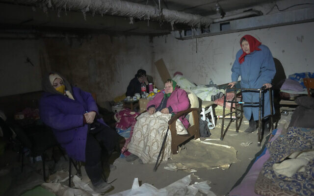 Elderly residents hide in a basement for shelter with no electricity, water or food in the center of the town of Irpin, some 25 km (16 miles) northwest of Kyiv, March 11, 2022 (AP Photo/Efrem Lukatsky)