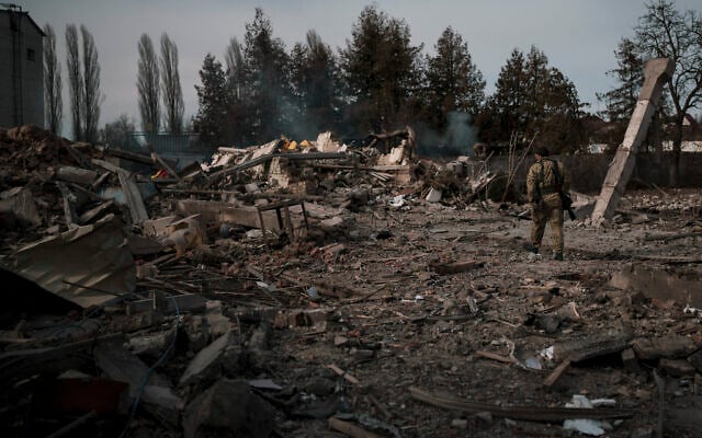 A volunteer of the Ukrainian Territorial Defense Forces walks on the debris of a car wash destroyed by a Russian bombing in Baryshivka, east of Kyiv, Ukraine, March 11, 2022. (AP Photo/Felipe Dana) A volunteer of the Ukrainian Territorial Defense Forces walks on the debris of a car wash destroyed by a Russian bombing in Baryshivka, east of Kyiv, Ukraine, March 11, 2022. (AP Photo/Felipe Dana)