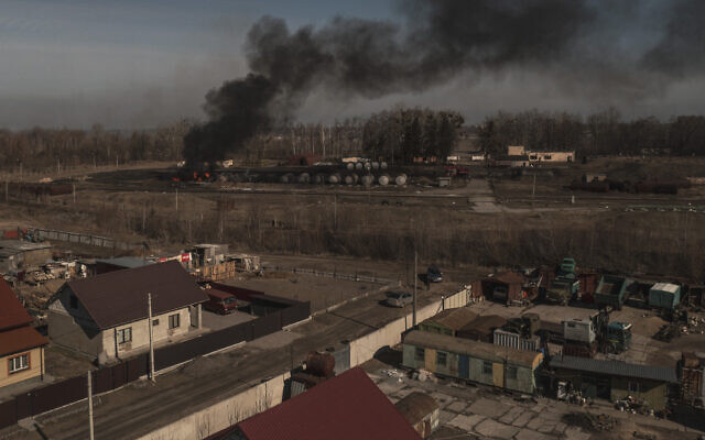 Smoke billows from burning containers after shelling in Vasylkiv, south west of Kyiv, Ukraine, on March 12, 2022. (AP Photo/Felipe Dana)
