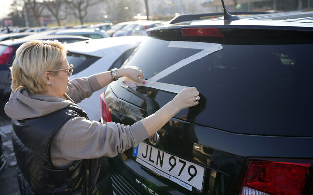 Illustrative: A woman glues a sticker with a letter Z to her car during a rally in support of Russia in Belgrade, Serbia, March 13, 2022. (AP Photo/Darko Vojinovic) Illustrative: A woman glues a sticker with a letter Z to her car during a rally in support of Russia in Belgrade, Serbia, March 13, 2022. (AP Photo/Darko Vojinovic)