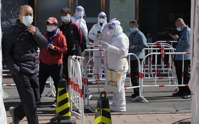 Workers line up for COVID test outside an office building in Beijing, March 14, 2022. (AP Photo/Ng Han Guan) Workers line up for COVID test outside an office building in Beijing, March 14, 2022. (AP Photo/Ng Han Guan)