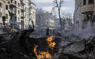 Firefighters extinguish flames outside an apartment house after a Russian rocket attack in Kharkiv, Ukraine's second-largest city, Ukraine, March 14, 2022. (AP Photo/Pavel Dorogoy) Firefighters extinguish flames outside an apartment house after a Russian rocket attack in Kharkiv, Ukraine's second-largest city, Ukraine, March 14, 2022. (AP Photo/Pavel Dorogoy)