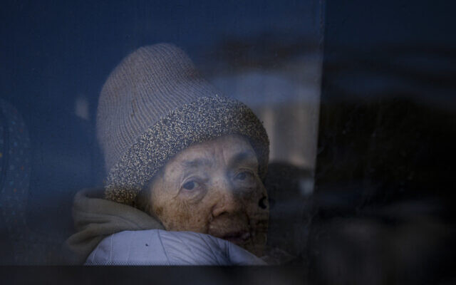 A refugee fleeing the war from neighboring Ukraine looks out a bus window after crossing the border, at the Romanian-Ukrainian border, in Siret, Romania, Monday, March 14, 2022. (AP Photo/Andreea Alexandru) A refugee fleeing the war from neighboring Ukraine looks out a bus window after crossing the border, at the Romanian-Ukrainian border, in Siret, Romania, Monday, March 14, 2022. (AP Photo/Andreea Alexandru)