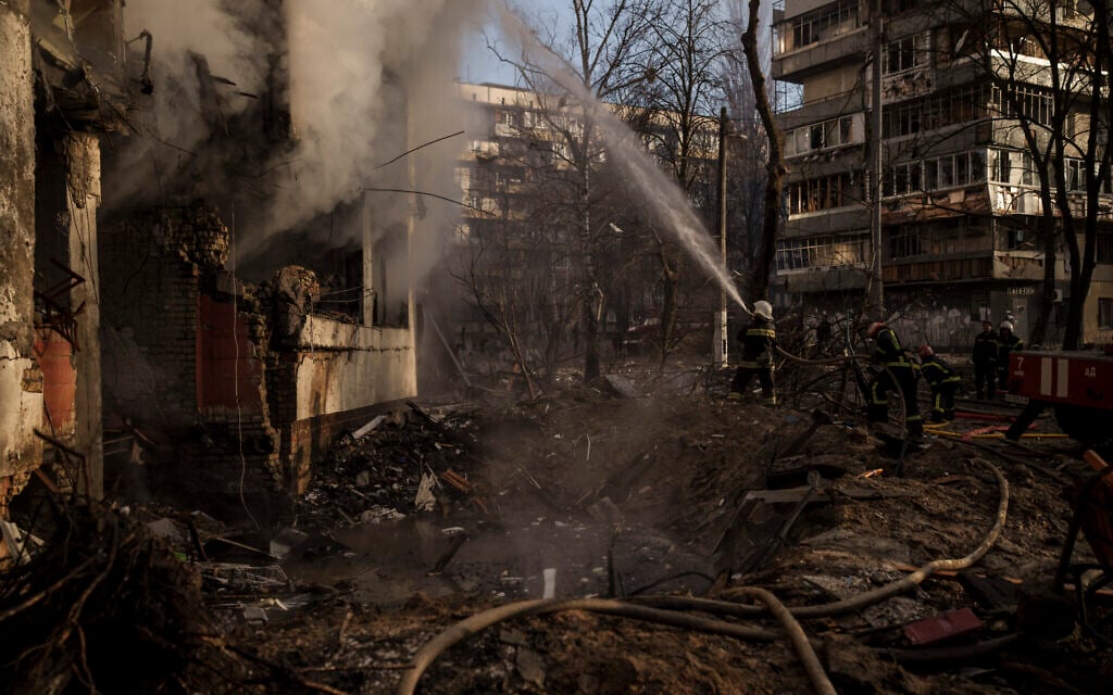 Ukrainian firefighters work in an apartment building after bombing in Kyiv, Ukraine, Tuesday, March 15, 2022. (AP Photo/Felipe Dana)