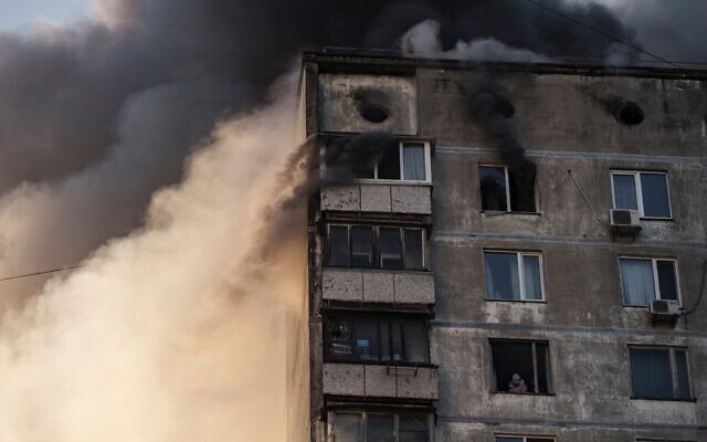 An elderly resident waits to be rescued by Ukrainian firefighters after bombing in an apartment building in Kyiv, Ukraine, Tuesday, March 15, 2022. (AP Photo/Felipe Dana) An elderly resident waits to be rescued by Ukrainian firefighters after bombing in an apartment building in Kyiv, Ukraine, Tuesday, March 15, 2022. (AP Photo/Felipe Dana)