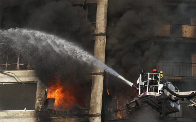Firefighters work in an apartment building damaged by shelling in Kyiv, Ukraine, Tuesday, March 15, 2022. (AP Photo/Efrem Lukatsky) Firefighters work in an apartment building damaged by shelling in Kyiv, Ukraine, Tuesday, March 15, 2022. (AP Photo/Efrem Lukatsky)
