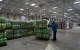 UNHCR staff load a truck with supplies for Ukraine in an aid warehouse at Rzeszow airport, in Rzeszow, southeastern Poland, March 16, 2022. (AP Photo/Petros Giannakouris)