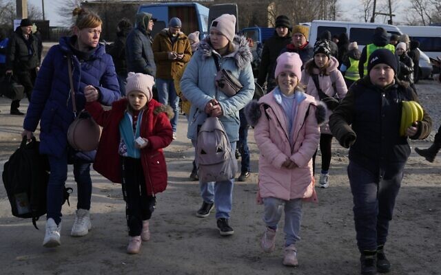 Refugees leaving to Romania after fleeing from Ukraine, walk at the border crossing in Palanca, Moldova, March 17, 2022. (AP Photo/Sergei Grits) Refugees leaving to Romania after fleeing from Ukraine, walk at the border crossing in Palanca, Moldova, March 17, 2022. (AP Photo/Sergei Grits)