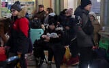 People who fled the war in Ukraine wait at the train station in Przemysl, southeastern Poland, Thursday, March 17, 2022. (AP Photo/Petros Giannakouris)