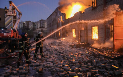 Ukrainian firefighters extinguish a blaze at a warehouse after a bombing in Kyiv, Ukraine, March 17, 2022. (AP Photo/Vadim Ghirda) Ukrainian firefighters extinguish a blaze at a warehouse after a bombing in Kyiv, Ukraine, March 17, 2022. (AP Photo/Vadim Ghirda)