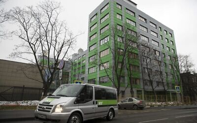 In this photo taken on October 27, 2017, a car of Russian state-owned television station RT passes by the company's office in Moscow, Russia. (AP Photo/Pavel Golovkin, file)