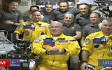 In this frame grab from video provided by Roscosmos, Russian cosmonauts Sergey Korsakov, Oleg Artemyev and Denis Matveyev are seen during a welcome ceremony after arriving at the International Space Station, Friday, March 18, 2022, the first new faces in space since the start of Russia’s war in Ukraine. The crew emerged from the Soyuz capsule wearing yellow flight suits with blue stripes, the colors of the Ukrainian flag. (Roscosmos via AP)
