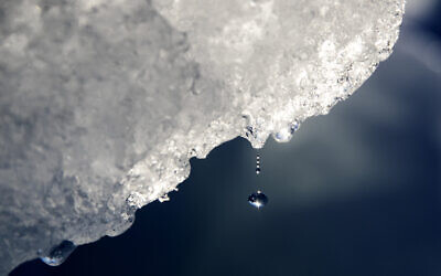 A drop of water falls off an iceberg melting in the Nuup Kangerlua Fjord near Nuuk in southwestern Greenland, Tuesday, Aug. 1, 2017. Earth’s poles are undergoing simultaneous freakish extreme heat with parts of Antarctica more than 70 degrees (40 degrees Celsius) warmer than average and areas of the Arctic more than 50 degrees (30 degrees Celsius) warmer than average. (AP Photo/David Goldman, File)