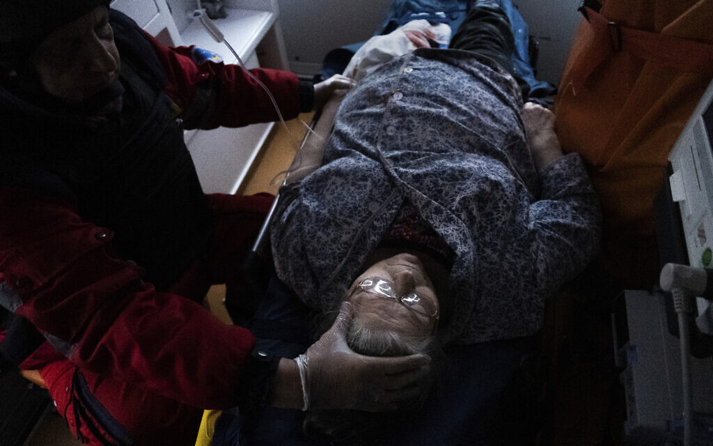 Ambulance paramedics transfer a woman wounded by shelling to a hospital in Mariupol, Ukraine, March 2, 2022. (Mstyslav Chernov/AP)