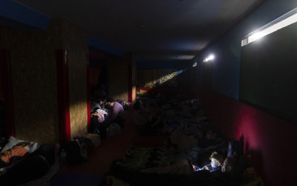 People prepare for the night in the improvised bomb shelter in a sports center, in Mariupol, Ukraine, Feb. 27, 2022. (Mstyslav Chernov/AP)