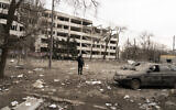 Associated Press photographer Evgeniy Maloletka stands amid rubble of an airstrike on Pryazovskyi State Technical University in Mariupol, Ukraine, March 10, 2022. (Mstyslav Chernov/AP)