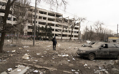 Associated Press photographer Evgeniy Maloletka stands amid rubble of an airstrike on Pryazovskyi State Technical University in Mariupol, Ukraine, March 10, 2022. (Mstyslav Chernov/AP)