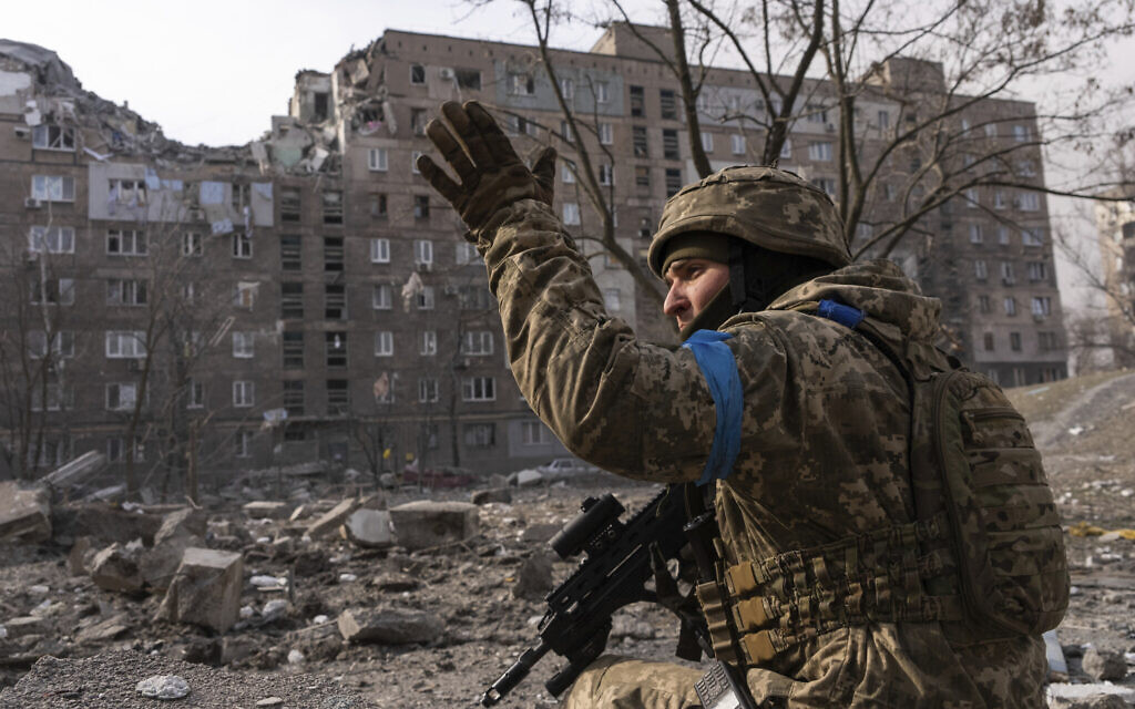 A Ukrainian serviceman guards his position in Mariupol, Ukraine, March 12, 2022. (Mstyslav Chernov/AP)