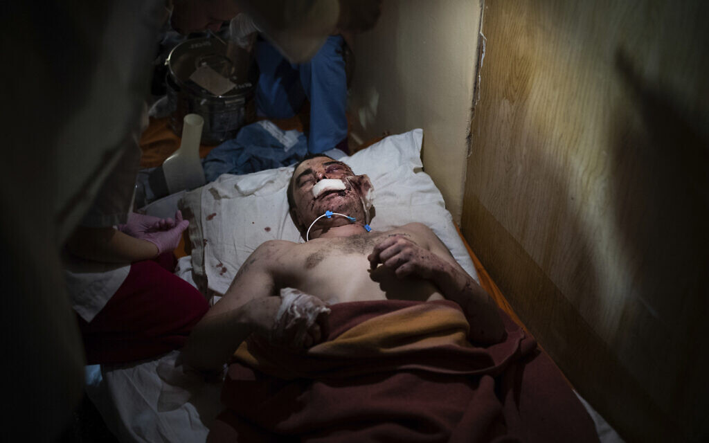 Medical workers treat a man, wounded by shelling, in a hospital in Mariupol, Ukraine, March 4, 2022. (Mstyslav Chernov/AP)