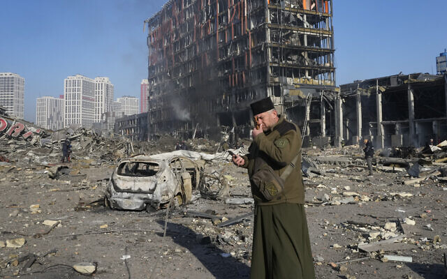 A priest prays by the ruins of a destroyed shopping center after shelling, in Kyiv, Ukraine, Monday, March 21, 2022. (AP Photo/Efrem Lukatsky) A priest prays by the ruins of a destroyed shopping center after shelling, in Kyiv, Ukraine, Monday, March 21, 2022. (AP Photo/Efrem Lukatsky)