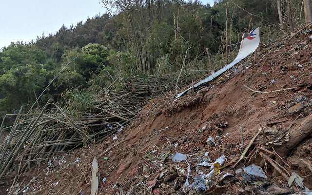 In this photo taken by mobile phone released by Xinhua News Agency, a piece of wreckage of the China Eastern's flight MU5735 is seen after it crashed on the mountain in Tengxian County, south China's Guangxi Zhuang Autonomous Region on March 21, 2022. (Xinhua via AP) In this photo taken by mobile phone released by Xinhua News Agency, a piece of wreckage of the China Eastern's flight MU5735 is seen after it crashed on the mountain in Tengxian County, south China's Guangxi Zhuang Autonomous Region on March 21, 2022. (Xinhua via AP)