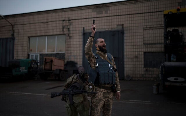 Serhii Volosovets, a commander in the Ukrainian Territorial Defense Forces, fires a pistol during a training camp for volunteers in Brovary, northeast of Kyiv, Ukraine, March 21, 2022. (AP Photo/Felipe Dana)