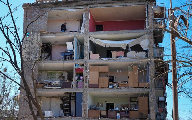 A man walks in his apartment ruined after the Russian shelling in Kyiv, Ukraine, March 21, 2022. (AP Photo/Efrem Lukatsky)