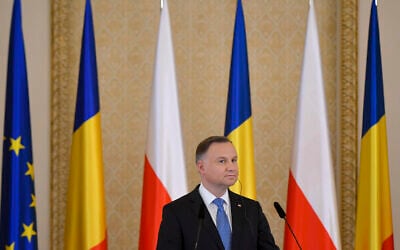 Poland's President Andrzej Duda listens to Romania's President Klaus Iohannis during press statements at the Presidential Palace in Bucharest, Romania, March 22, 2022. (AP Photo/Andreea Alexandru)