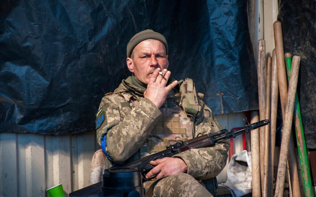 Ukrainian serviceman has a rest on his position in Kharkiv, Ukraine, March 22, 2022. (AP Photo/Andrew Marienko)