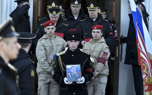 A serviceman carries the photo of Capt. Andrei Paliy, a deputy commander of Russia's Black Sea Fleet, during a farewell ceremony in Sevastopol, Crimea, March 23, 2022. Paliy was killed in action during fighting with Ukrainian forces in the Sea of Azov port of Mariupol. (AP Photo) A serviceman carries the photo of Capt. Andrei Paliy, a deputy commander of Russia's Black Sea Fleet, during a farewell ceremony in Sevastopol, Crimea, March 23, 2022. Paliy was killed in action during fighting with Ukrainian forces in the Sea of Azov port of Mariupol. (AP Photo)