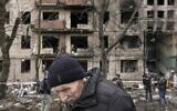 An elderly man walks outside an apartment block which was destroyed by an artillery strike in Kyiv, Ukraine, March 14, 2022. (AP Photo/Vadim Ghirda)