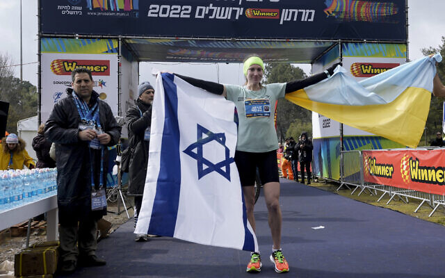 Ukrainian runner Valentyna Veretska poses with the Ukrainian and Israeli flags after finishing first among women in the Jerusalem marathon, March 25, 2022. (AP Photo/Mahmoud Illean) Ukrainian runner Valentyna Veretska poses with the Ukrainian and Israeli flags after finishing first among women in the Jerusalem marathon, March 25, 2022. (AP Photo/Mahmoud Illean)
