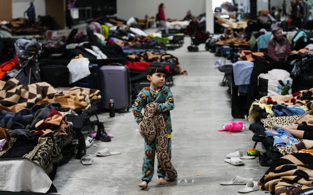 A child walks with a toy in a refugee center in Nadarzyn, near Warsaw, Poland, on March 25, 2022. (AP Photo/Petr David Josek)