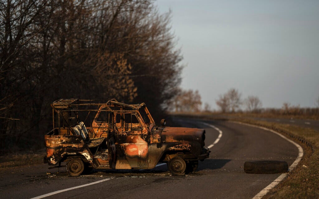A burned Ukranian army vehicle stands on a street leading to the airport of the city of Mykolaiv, Ukraine, March 25, 2022.(AP Photo/Petros Giannakouris)