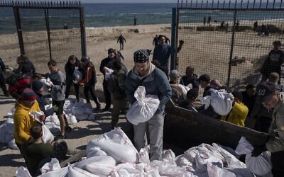Volunteers load a vehicle with sandbags to defend the city, in Odesa, southern Ukraine, on March 23, 2022 (AP Photo/Petros Giannakouris, File)